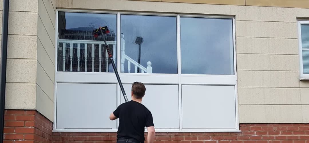 Ground floor windows being cleaned for a block of flats